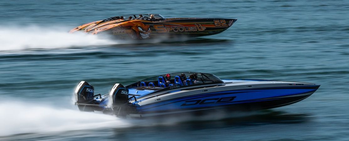 Two boats speed through the channel at the 1000 Islands Charity Poker Run in Clayton NY